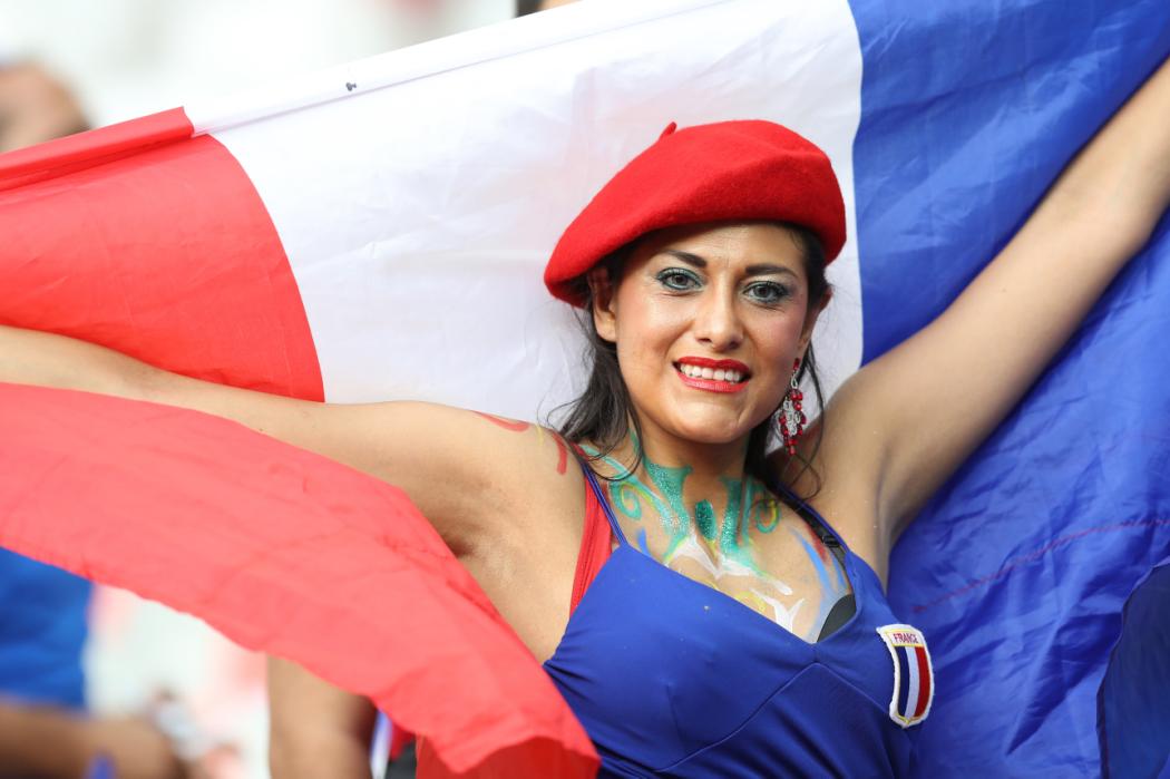 A France fan wearing a red beret holds up a French flag ahead of the Euro 2016 final football match between Portugal and France at the Stade de France in Saint-Denis, north of Paris, on July 10, 2016. / AFP PHOTO / Valery HACHE