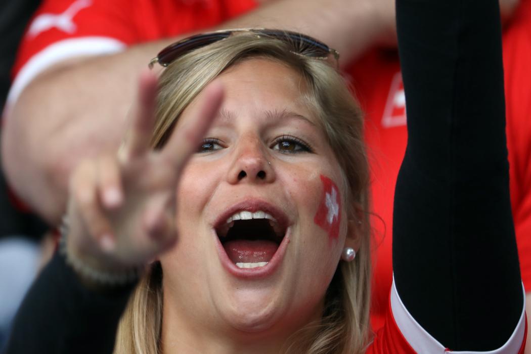 A Switzerland supporter poses prior to the Euro 2016 group A football match between Switzerland and France at the Pierre-Mauroy stadium in Lille on June 19, 2016. / AFP PHOTO / KENZO TRIBOUILLARD