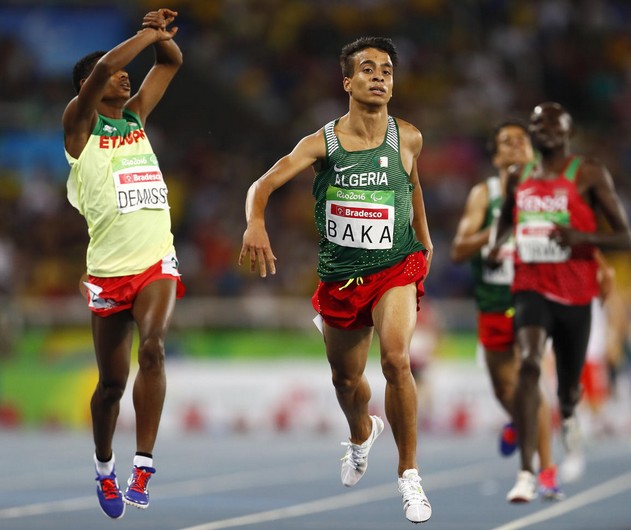 2016 Rio Paralympics - Athletics - Men's 1500m - T13 Final - Olympic Stadium - Rio de Janeiro, Brazil - 11/09/2016. Abdellatif Baka of Algeria (C) wins the gold medal in the event while Tamiru Demisse of Ethiopia (L) takes the silver. REUTERS/Jason Cairnduff FOR EDITORIAL USE ONLY. NOT FOR SALE FOR MARKETING OR ADVERTISING CAMPAIGNS. - RTSN9WG