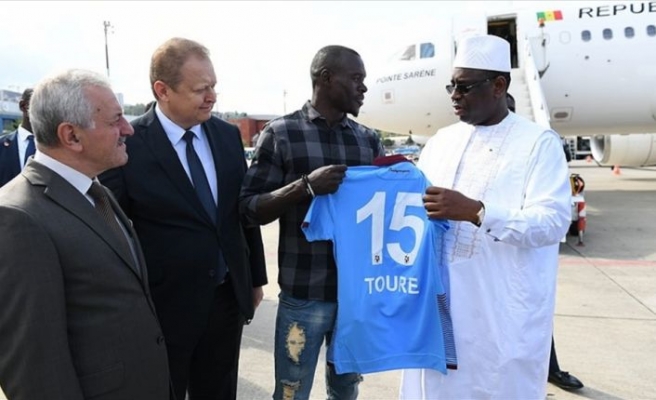 Arrêt sur image: Macky Sall rencontre le défenseur des Lions Zargo Touré qui lui offre son maillot