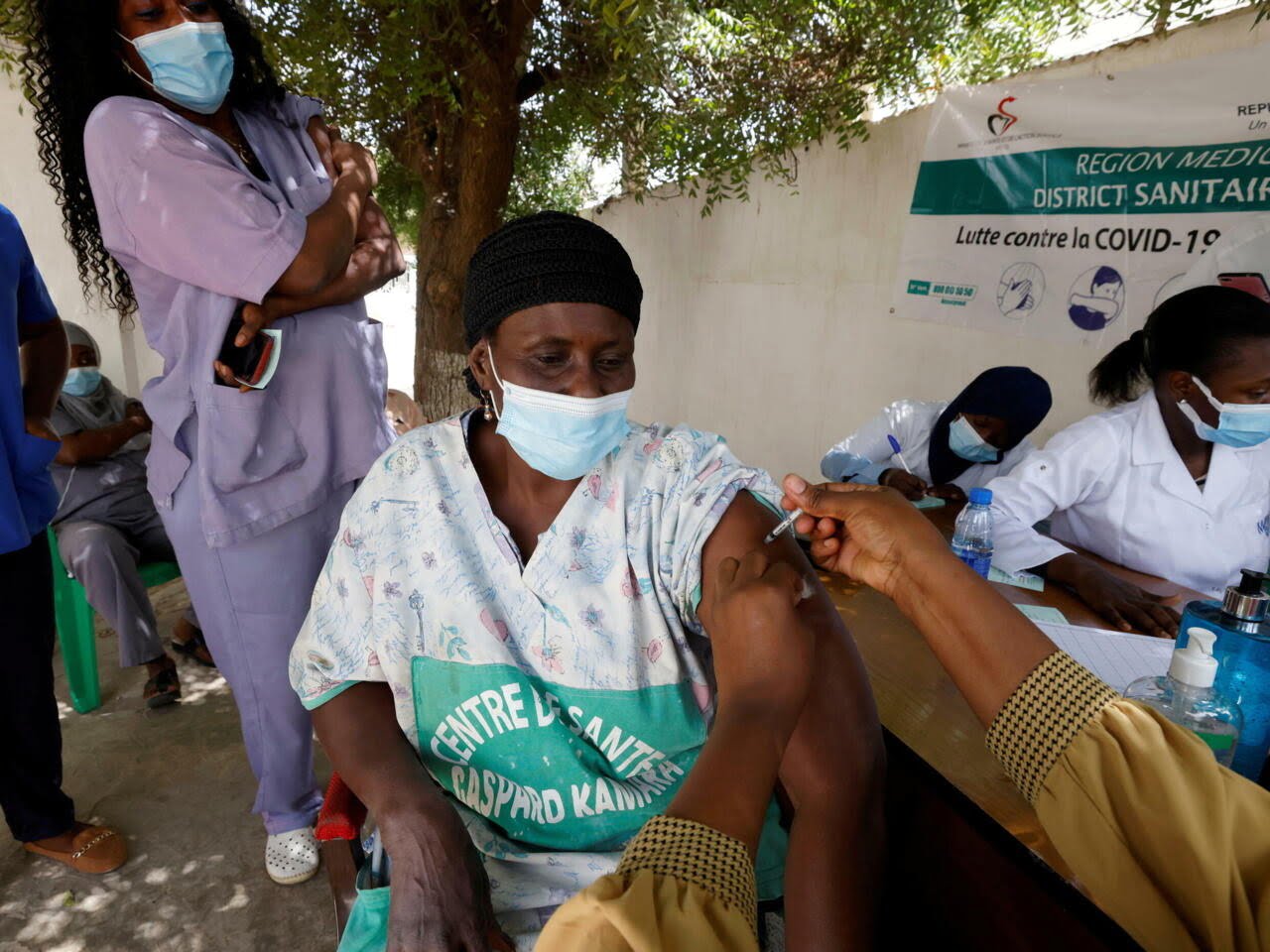 FILE PHOTO: A health worker receives a dose of coronavirus disease (COVID-19) vaccine in Dakar